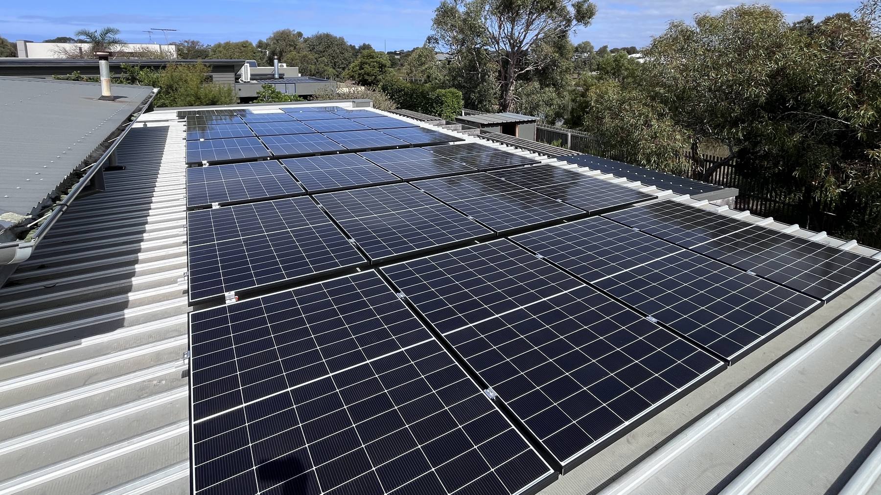 Solar panels installed across a metal roof by Sulex Electrics